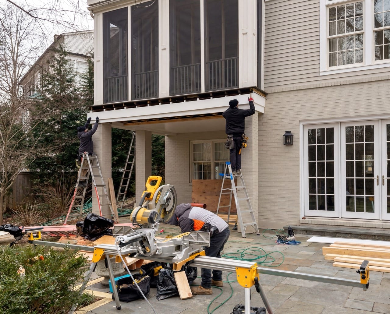 RBE's crew on ladders at the porch beam, saws set up on the patio below, Washington, DC
