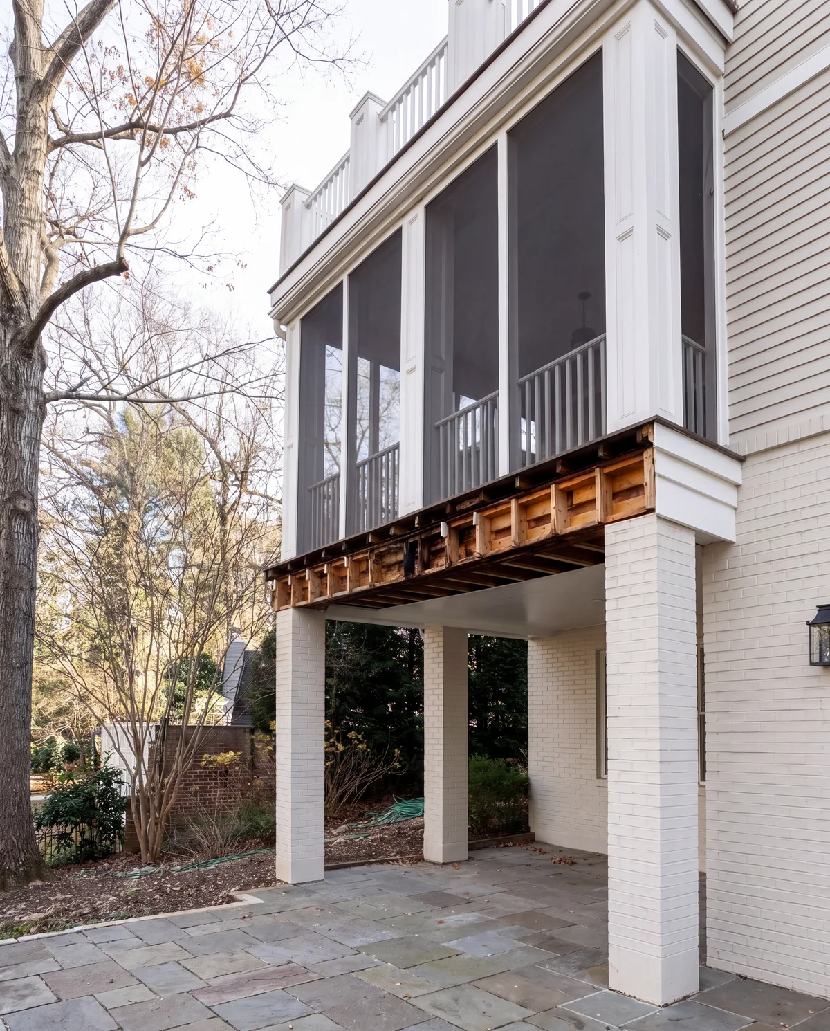 The underside of a screened porch with the beam opened up and rot exposed, Washington, DC