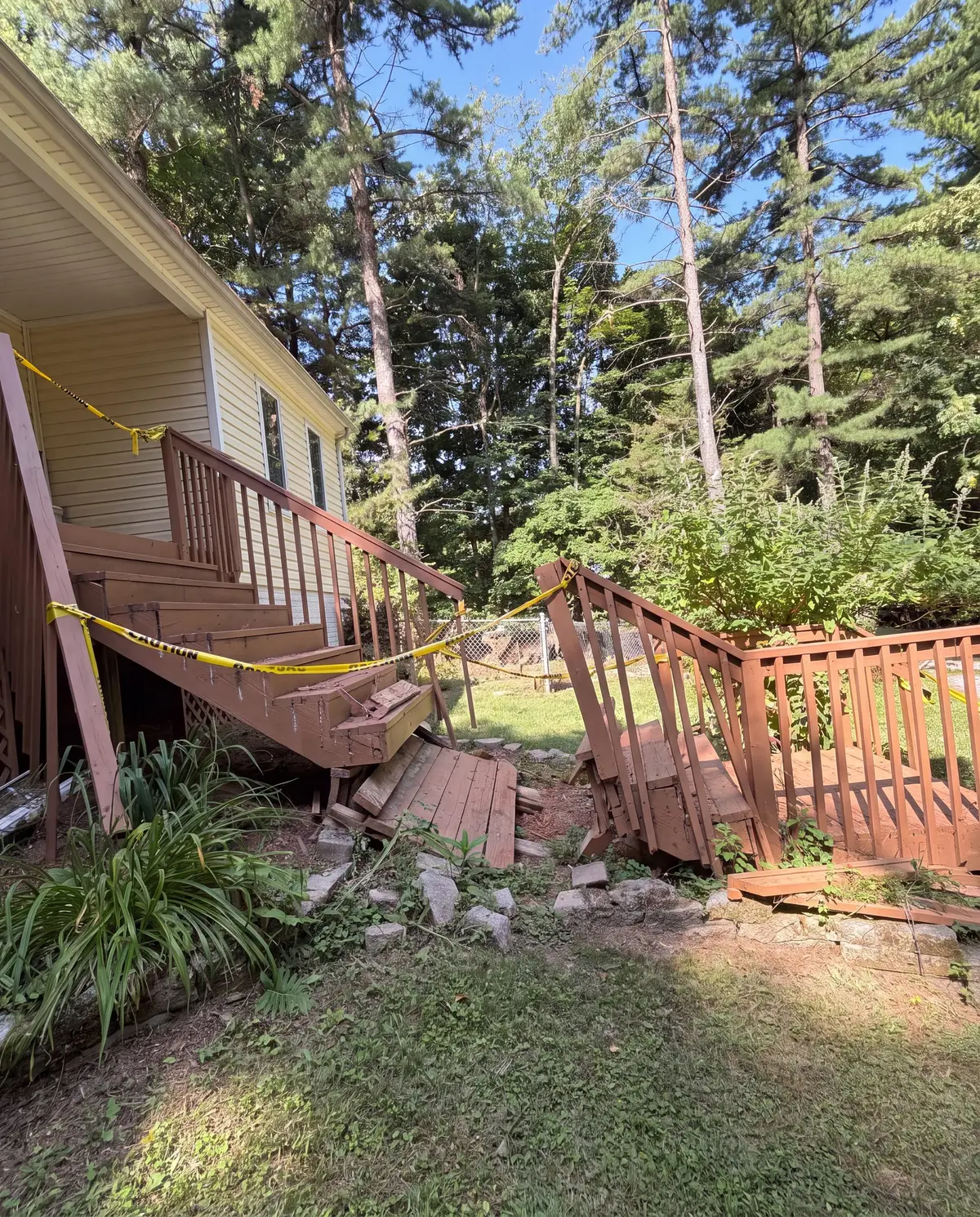 Collapsed wooden back stairs with caution tape across them, Frederick, MD